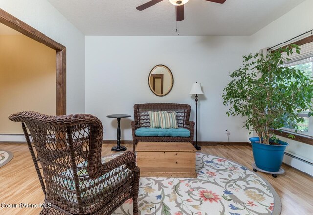 684 Chute Canyon Way, Bonners Ferry, ID 83805 - living area with wood finished floors, ceiling fan, and baseboards