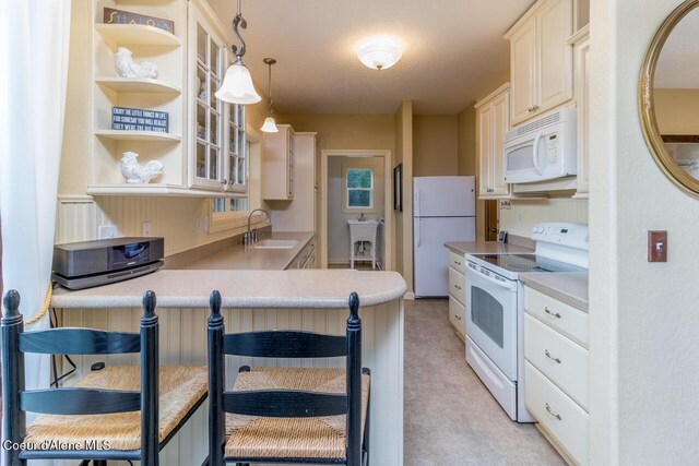 684 Chute Canyon Way, Bonners Ferry, ID 83805 - kitchen featuring white appliances, a sink, a peninsula, glass insert cabinets, and light countertops