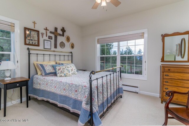 684 Chute Canyon Way, Bonners Ferry, ID 83805 - bedroom with a baseboard heating unit, carpet, baseboards, and ceiling fan