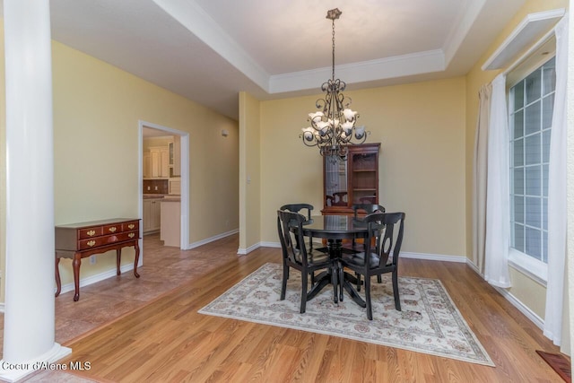 684 Chute Canyon Way, Bonners Ferry, ID 83805 - dining area with a chandelier, a tray ceiling, light wood finished floors, and ornamental molding
