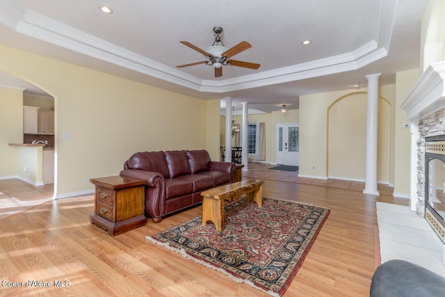 684 Chute Canyon Way, Bonners Ferry, ID 83805 - living area featuring decorative columns, a tray ceiling, ceiling fan, ornamental molding, and light wood-style floors