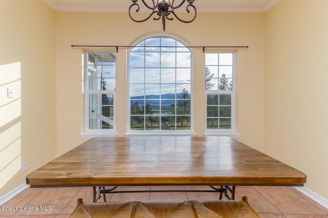 684 Chute Canyon Way, Bonners Ferry, ID 83805 - tiled dining room featuring a chandelier, baseboards, a mountain view, and ornamental molding