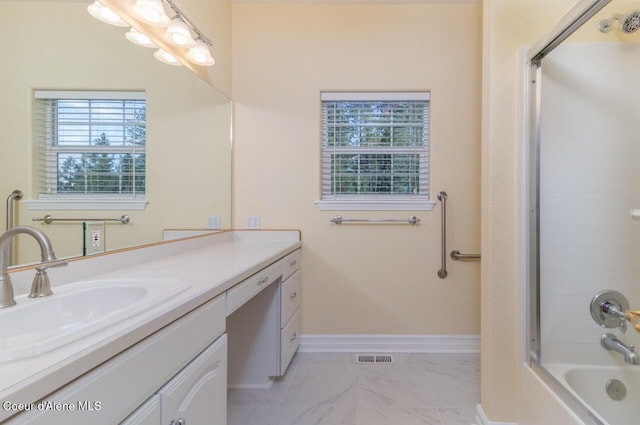 684 Chute Canyon Way, Bonners Ferry, ID 83805 - bathroom with marble look tiles, vanity, baseboards, and tub / shower combination