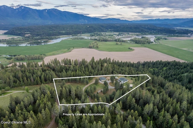 684 Chute Canyon Way, Bonners Ferry, ID 83805 - aerial overview of property's location featuring a water and mountain view, property boundaries highlighted, and a heavily wooded area