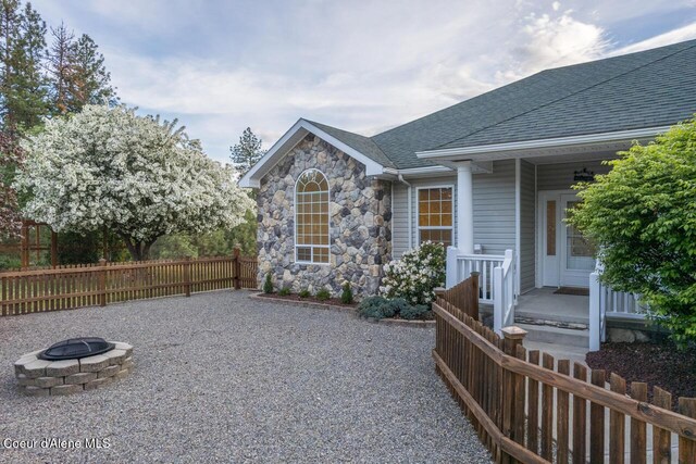 684 Chute Canyon Way, Bonners Ferry, ID 83805 - view of patio with an outdoor fire pit and fence
