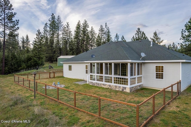 684 Chute Canyon Way, Bonners Ferry, ID 83805 - rear view of house featuring roof with shingles and a sunroom