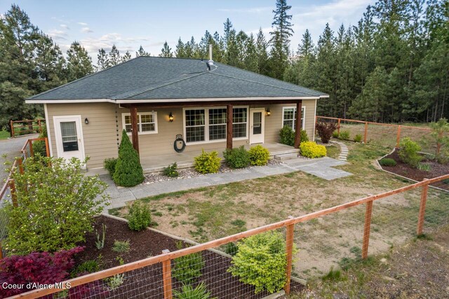 684 Chute Canyon Way, Bonners Ferry, ID 83805 - view of front of property with a shingled roof, a fenced backyard, and a patio