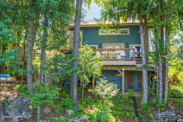 7547 W Channel Ln, Rathdrum, ID 83858 - rear view of property with a deck, metal roof, and a standing seam roof