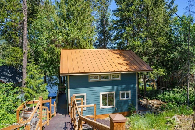 7547 W Channel Ln, Rathdrum, ID 83858 - back of house with a deck, metal roof, and a standing seam roof