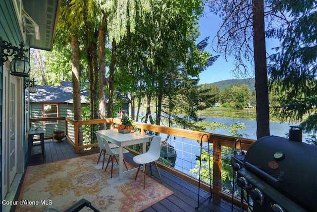 7547 W Channel Ln, Rathdrum, ID 83858 - deck with outdoor dining space, a grill, and a mountain view
