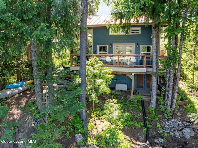 7547 W Channel Ln, Rathdrum, ID 83858 - rear view of house with a deck, a standing seam roof, french doors, and metal roof