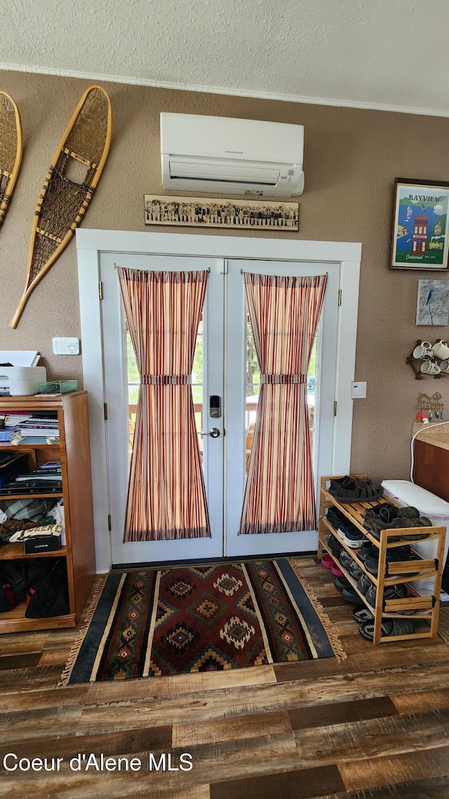 16646 E Cape Horn Rd, Bayview, ID 83803 - entryway with a wall mounted AC, a textured wall, wood finished floors, a textured ceiling, and french doors