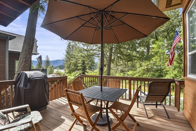 16646 E Cape Horn Rd, Bayview, ID 83803 - wooden terrace with a mountain view, outdoor dining area, and area for grilling