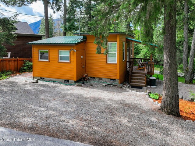 16646 E Cape Horn Rd, Bayview, ID 83803 - view of front of property with crawl space, a wooden deck, and metal roof