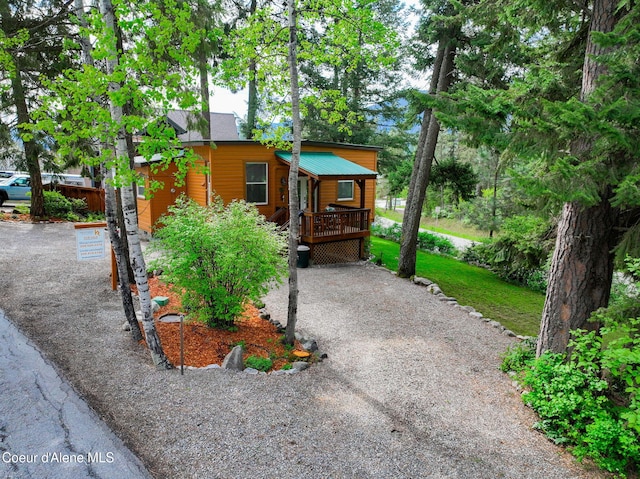 16646 E Cape Horn Rd, Bayview, ID 83803 - rustic home featuring a wooden deck and gravel driveway