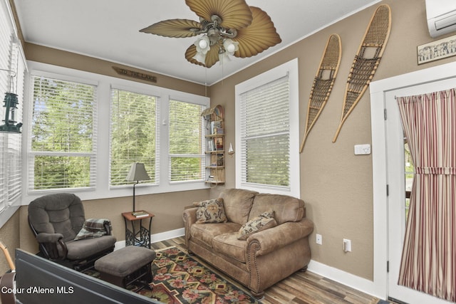 16646 E Cape Horn Rd, Bayview, ID 83803 - living room featuring wood finished floors, a wall unit AC, a ceiling fan, baseboards, and a textured wall