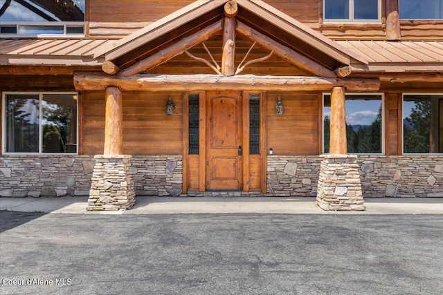 5239 E Dodd Rd, Hayden, ID 83835 - property entrance featuring stone siding, metal roof, and a standing seam roof