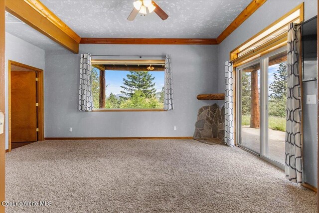 5239 E Dodd Rd, Hayden, ID 83835 - empty room with carpet floors, plenty of natural light, a ceiling fan, a textured ceiling, and baseboards