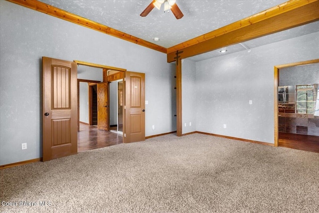 5239 E Dodd Rd, Hayden, ID 83835 - unfurnished room with carpet flooring, ceiling fan, beam ceiling, and baseboards