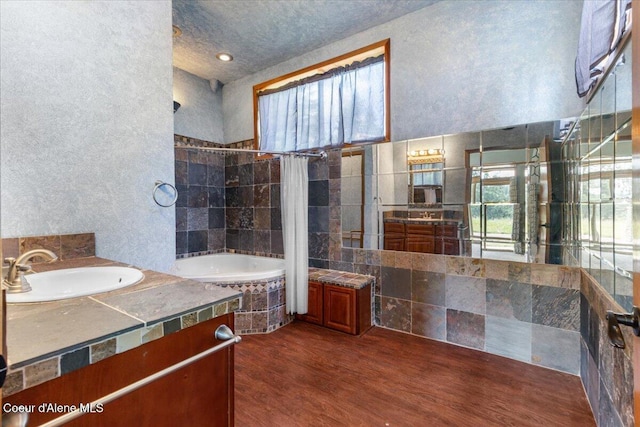 5239 E Dodd Rd, Hayden, ID 83835 - full bath with vanity, tiled shower / bath, and wood finished floors
