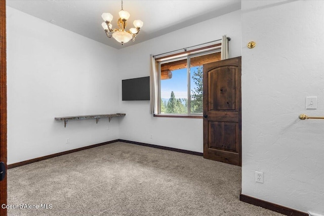 5239 E Dodd Rd, Hayden, ID 83835 - carpeted empty room with a chandelier and baseboards