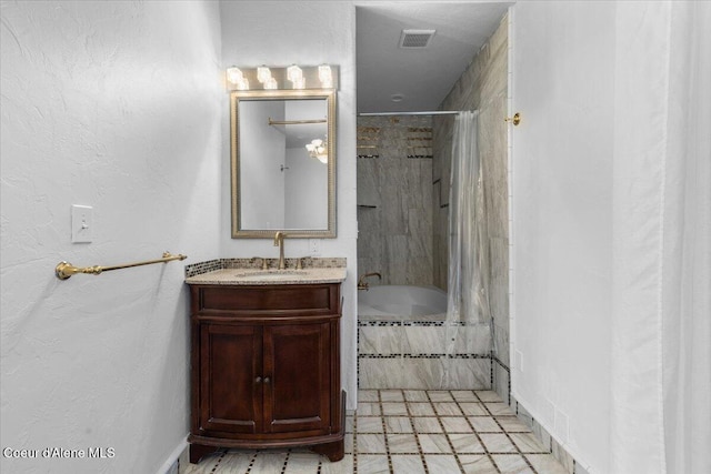 5239 E Dodd Rd, Hayden, ID 83835 - bathroom with tiled shower / bath, vanity, and baseboards