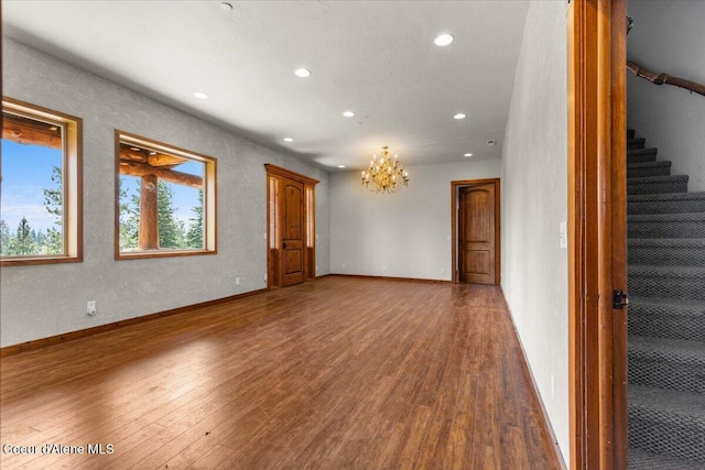 5239 E Dodd Rd, Hayden, ID 83835 - unfurnished living room with recessed lighting, a chandelier, stairway, wood finished floors, and baseboards
