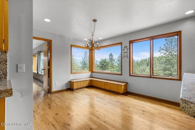 5239 E Dodd Rd, Hayden, ID 83835 - unfurnished dining area featuring light wood-type flooring, a chandelier, recessed lighting, and baseboards