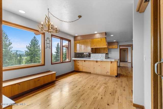 5239 E Dodd Rd, Hayden, ID 83835 - kitchen featuring a peninsula, a chandelier, light countertops, light wood-type flooring, and recessed lighting