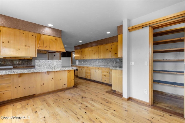 5239 E Dodd Rd, Hayden, ID 83835 - kitchen featuring tasteful backsplash, light brown cabinetry, light wood-style floors, recessed lighting, and a breakfast bar area
