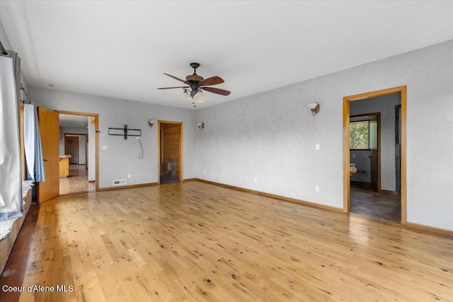 5239 E Dodd Rd, Hayden, ID 83835 - empty room featuring light wood finished floors, a ceiling fan, and baseboards
