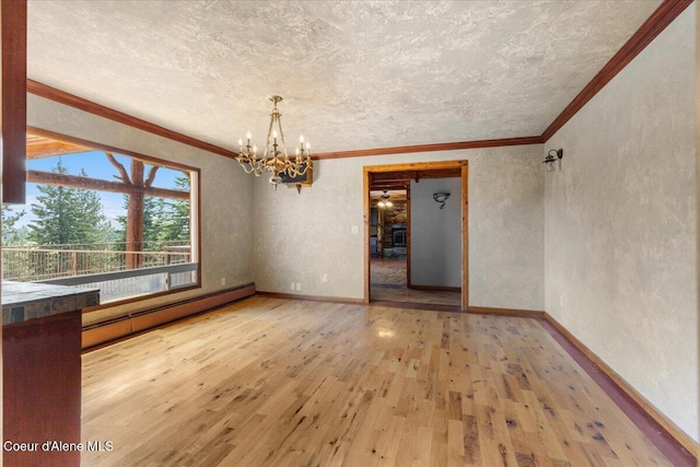5239 E Dodd Rd, Hayden, ID 83835 - unfurnished room with a baseboard radiator, a chandelier, hardwood / wood-style floors, ornamental molding, and a textured ceiling