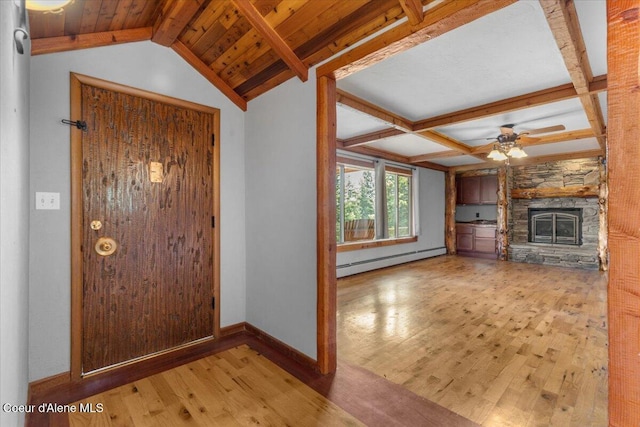 5239 E Dodd Rd, Hayden, ID 83835 - foyer featuring a baseboard radiator, wood finished floors, a ceiling fan, beamed ceiling, and a stone fireplace