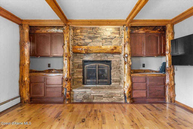 5239 E Dodd Rd, Hayden, ID 83835 - unfurnished living room with light wood-type flooring, baseboard heating, a stone fireplace, beam ceiling, and baseboards