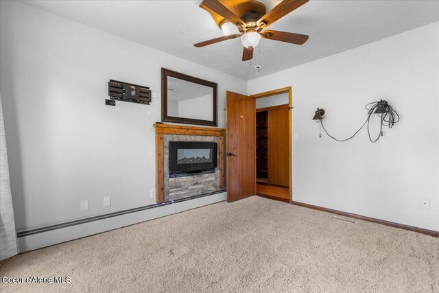 5239 E Dodd Rd, Hayden, ID 83835 - unfurnished living room with a baseboard heating unit, carpet floors, a ceiling fan, and baseboards