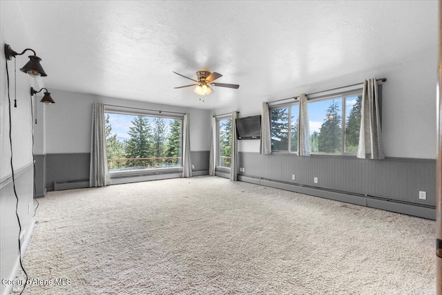 5239 E Dodd Rd, Hayden, ID 83835 - carpeted spare room with baseboard heating, wainscoting, ceiling fan, and a textured ceiling