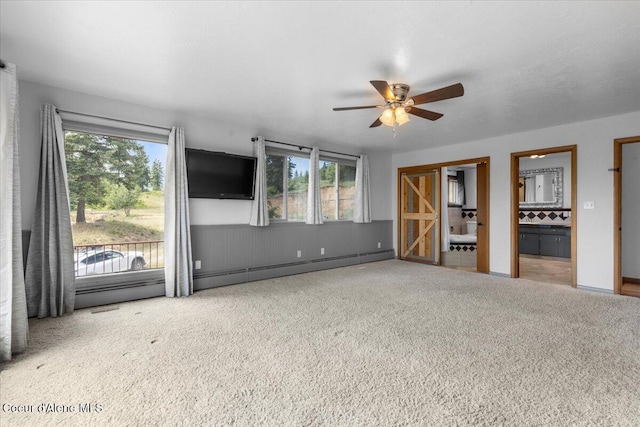 5239 E Dodd Rd, Hayden, ID 83835 - unfurnished living room with carpet flooring, a ceiling fan, and plenty of natural light