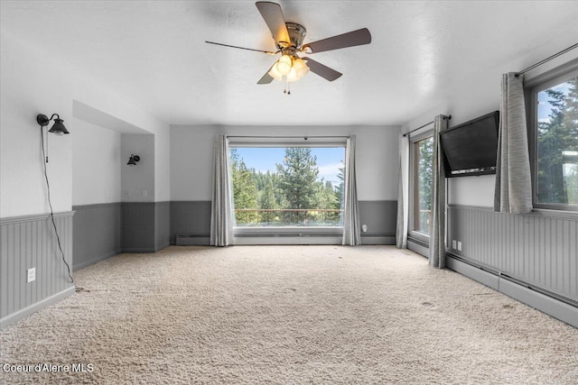 5239 E Dodd Rd, Hayden, ID 83835 - spare room with carpet, a ceiling fan, wainscoting, and baseboard heating