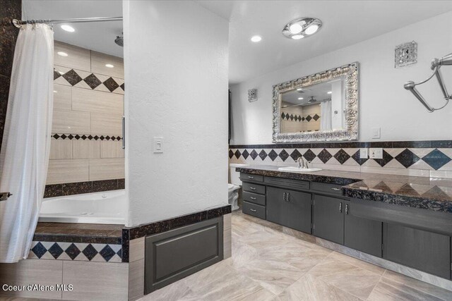 5239 E Dodd Rd, Hayden, ID 83835 - bathroom with tiled bath, vanity, tiled shower, tile walls, and recessed lighting