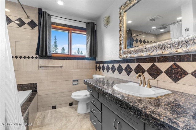 5239 E Dodd Rd, Hayden, ID 83835 - full bath with tile walls, vanity, toilet, and tiled shower / bath