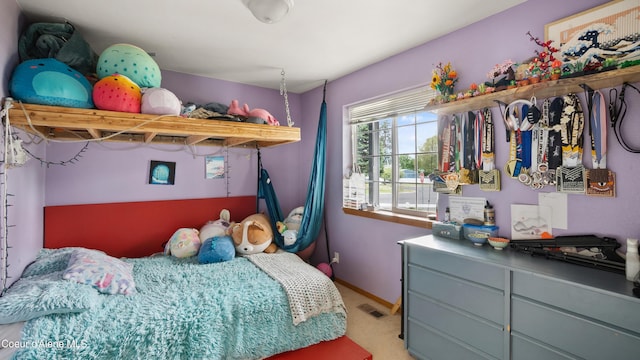 bedroom with light carpet and baseboards