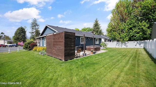 back of house featuring a hot tub and a patio