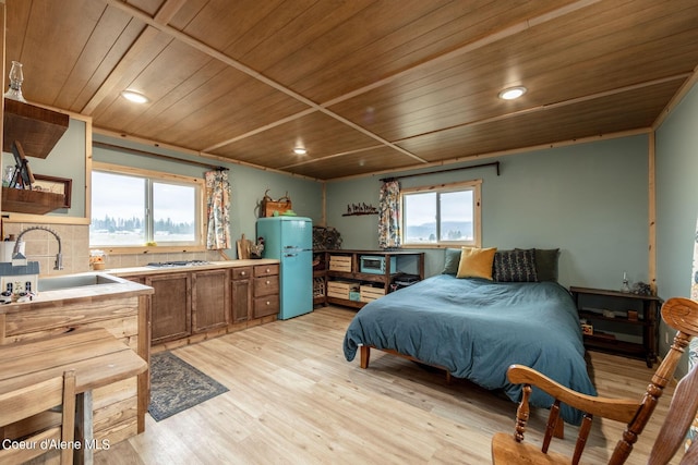bedroom featuring wood ceiling, a sink, freestanding refrigerator, light wood finished floors, and recessed lighting