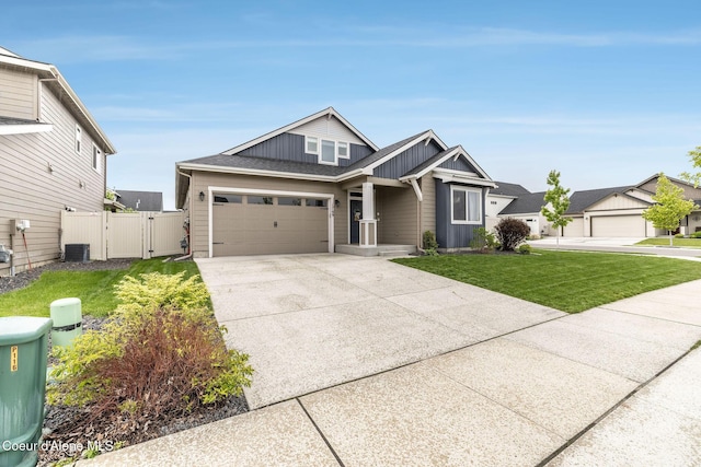 1769 N Chetco Dr, Post Falls, ID 83854 - view of front of house with a gate, board and batten siding, concrete driveway, central AC, and a garage