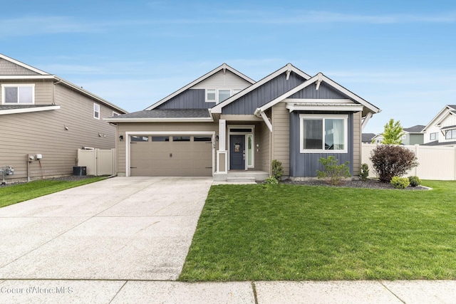 1769 N Chetco Dr, Post Falls, ID 83854 - craftsman house with board and batten siding, an attached garage, concrete driveway, and central AC unit