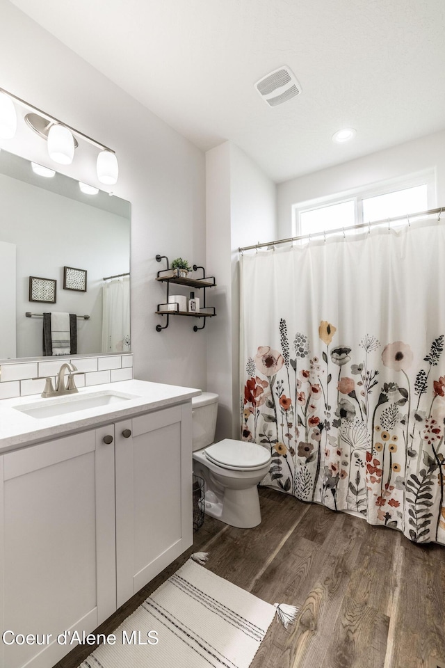 1769 N Chetco Dr, Post Falls, ID 83854 - full bathroom with wood finished floors, toilet, vanity, and a shower with shower curtain