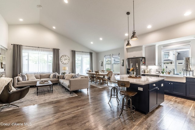 1769 N Chetco Dr, Post Falls, ID 83854 - kitchen with stainless steel fridge with ice dispenser, open floor plan, a kitchen breakfast bar, a kitchen island, and light countertops