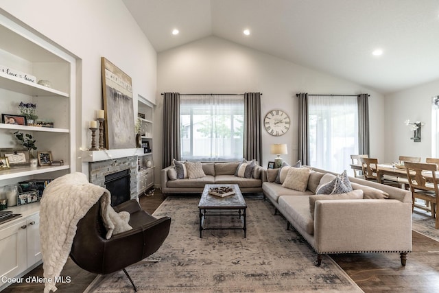 1769 N Chetco Dr, Post Falls, ID 83854 - living area with wood finished floors, a stone fireplace, high vaulted ceiling, and recessed lighting