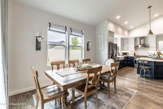 1769 N Chetco Dr, Post Falls, ID 83854 - dining room featuring wood finished floors, lofted ceiling, recessed lighting, and baseboards