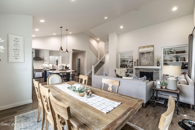 1769 N Chetco Dr, Post Falls, ID 83854 - dining room featuring stairway, dark wood finished floors, recessed lighting, a stone fireplace, and built in features